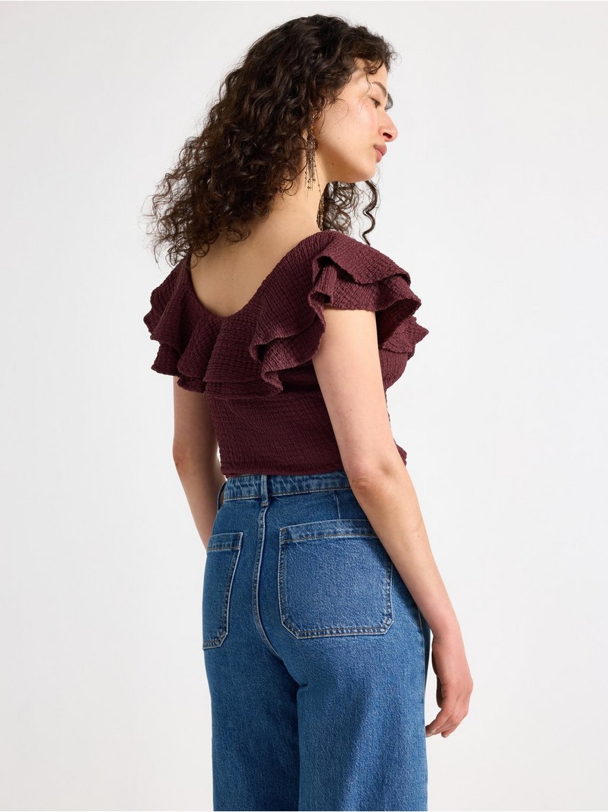 Sleeveless top with flounce