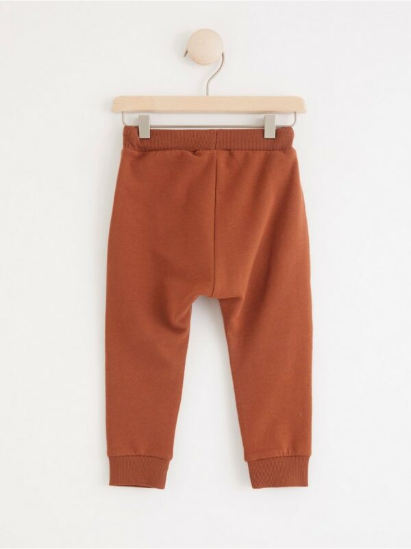 Trousers with bear knee patches